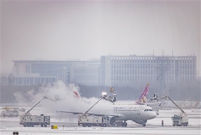 Aircraft deicing operation at Beijing Daxing International Airport in winter snow